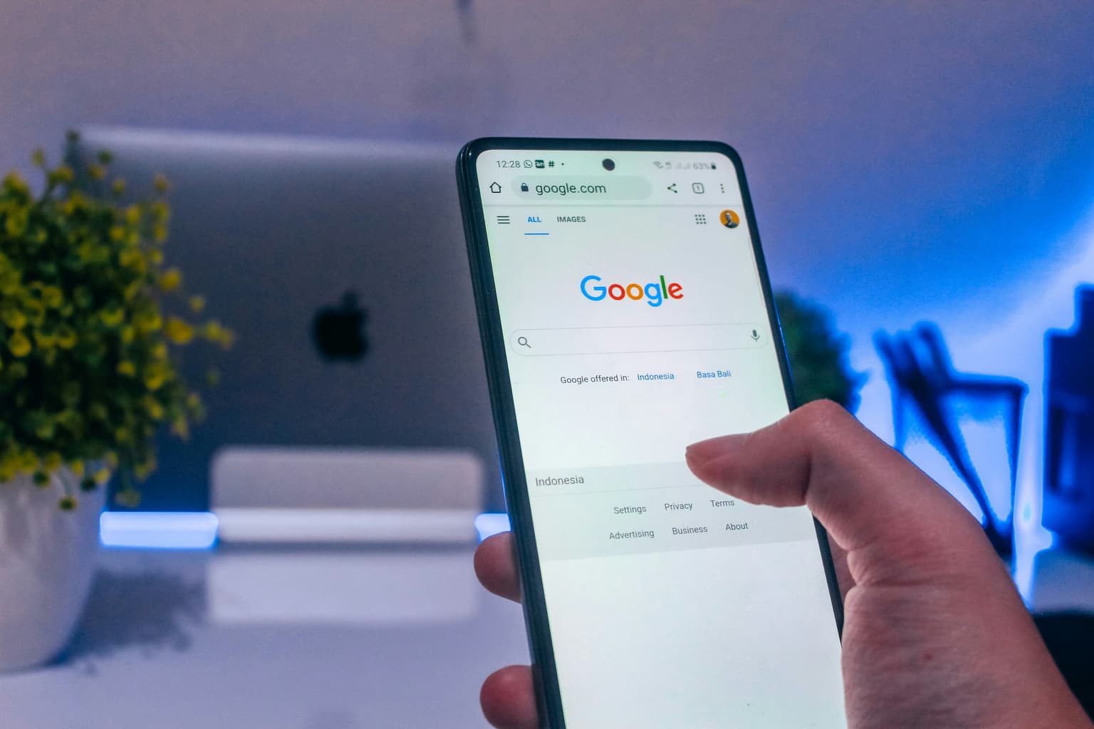 hand holding phone open on google app